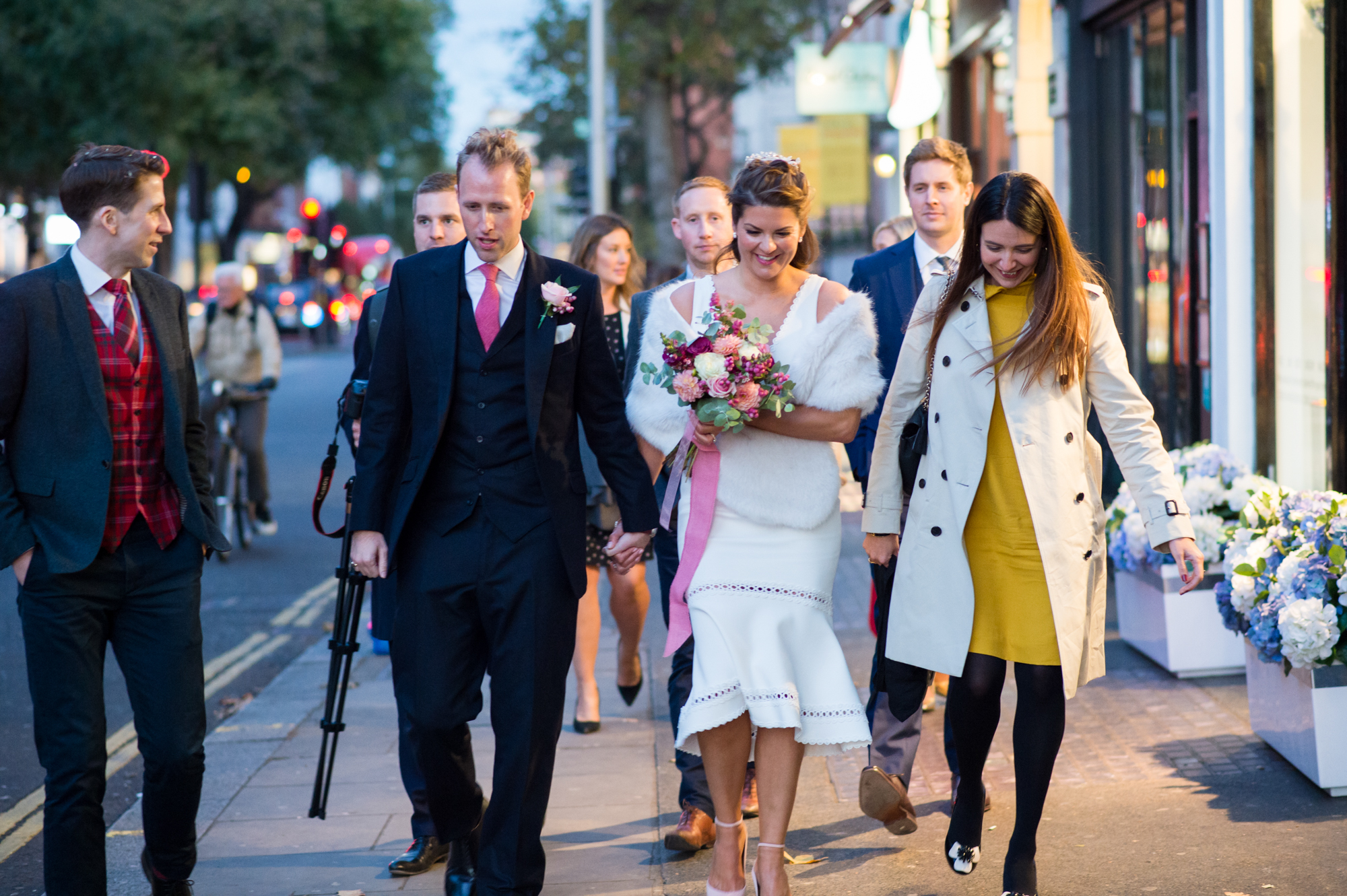 bride and groom walking with guests to their reception on Kings Road London